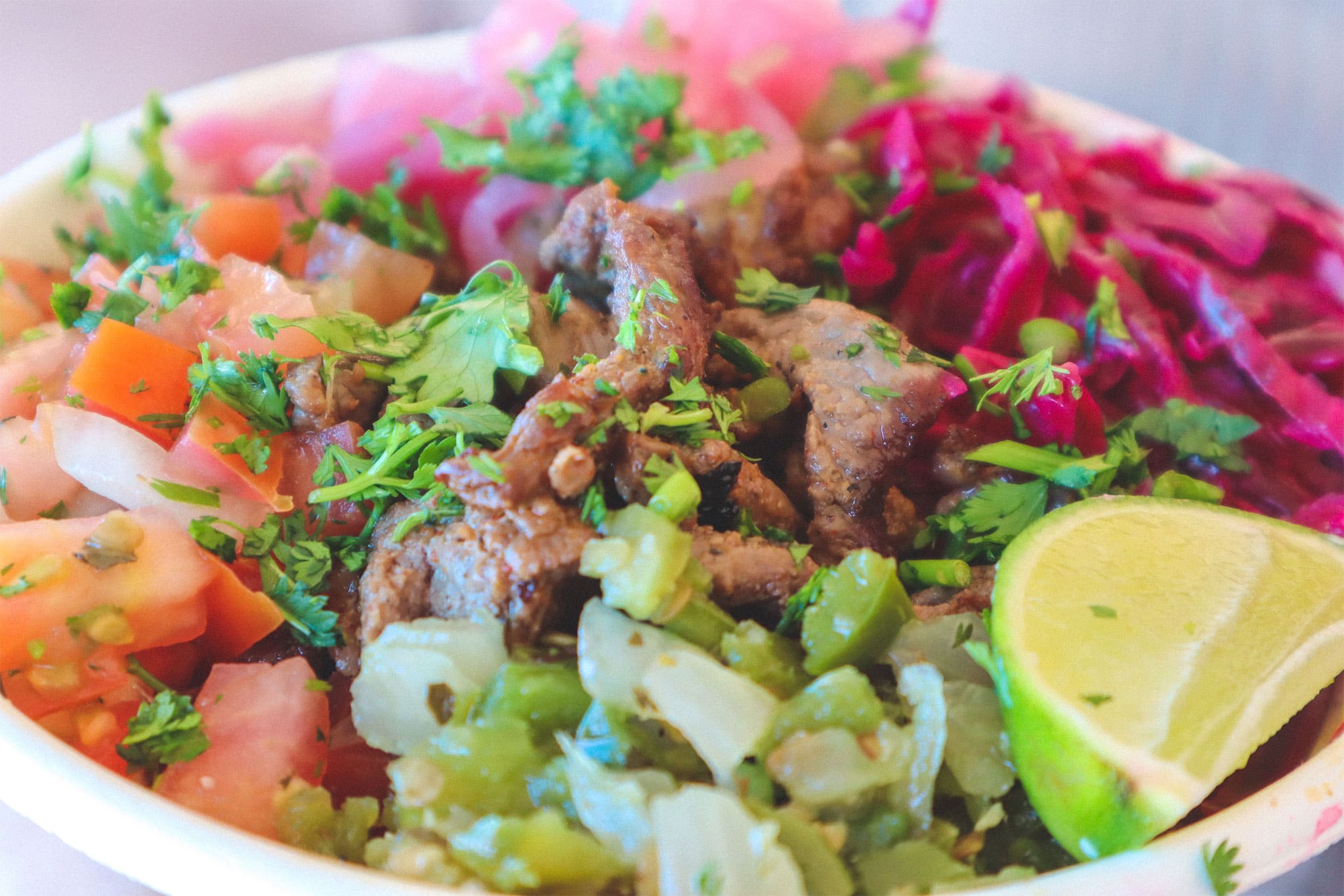 Close up photo of Poppo's bowl with beef and pico de gallo