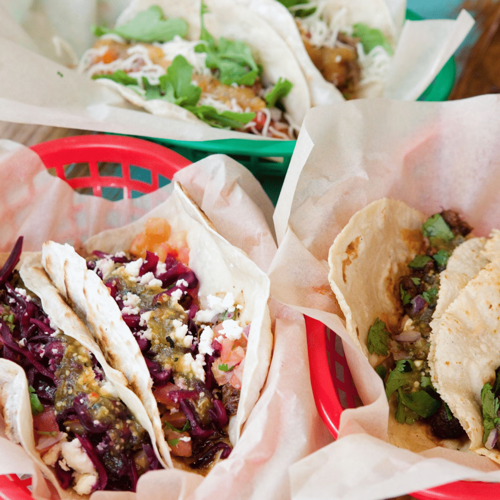 Baskets of diverse tacos sitting on a table